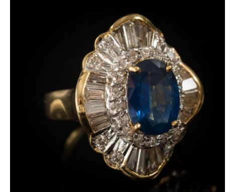 A sapphire and diamond ballerina cluster ring: centring an oval sapphire approximately 11mm long x 8.3mm x 4mm deep in four-c