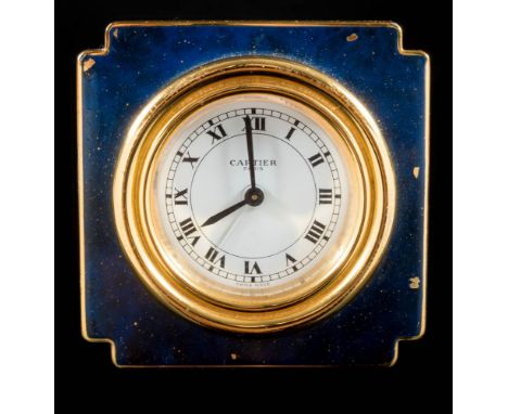 Cartier. A gilt-brass and blue enamelled alarm clock: the round white dial having black Roman hour numerals, baton hands, ala