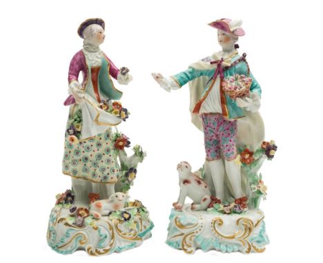 A pair of Derby figures of 'The Dresden Shepherds': the shepherdess wearing a puce coat, patterned yellow skirt and holding  