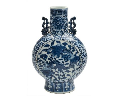 A Chinese blue and white moon flask: with pierced foliate handles, painted on each side with a sinuous scaly dragon amongst f