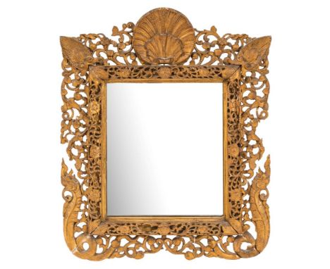 A 19th Century Indian carved gilt wood easel mirror:, with scallop shell cresting, the rectangular plate within a pierced flo
