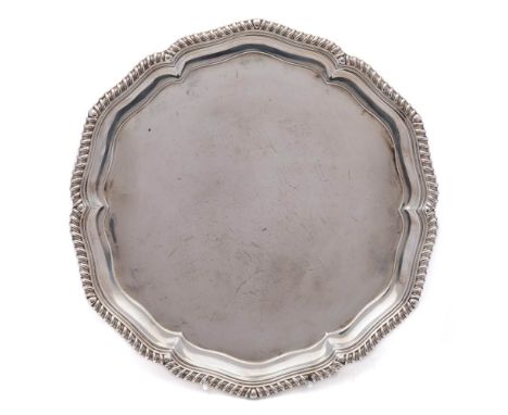 A George V silver salver, maker Martin, Hall &amp; Co, Sheffield, 1919: of circular outline with a gadrooned rim, raised on t