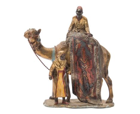 After Franz Bergman a twentieth century cold painted spelter table lighter: of a camel and carpet sellers, with painted decor