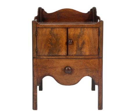 A George III mahogany tray top commode:, the shaped three quarter gallery with integral carrying handles, the front enclosed 