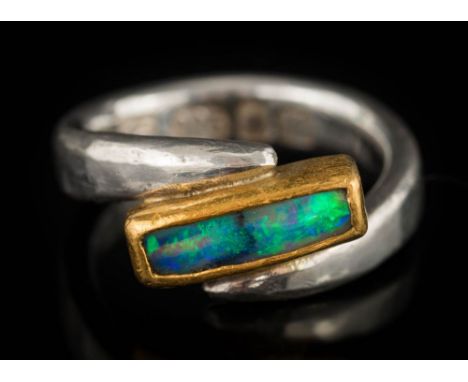 Charmian Harris. A silver and opal cross-over ring: maker's mark 'CH', London hallmark, approximately ring size M 1/2, 7gms g