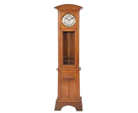 An Art Nouveau oak chiming longcase clock: the eight-day duration, weight-driven movement having brass bound weights, hour st