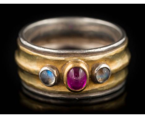 Alex Everitt. A moonstone and cabochon ruby three-stone, two-colour band: the shank with maker's mark, ring size O. 