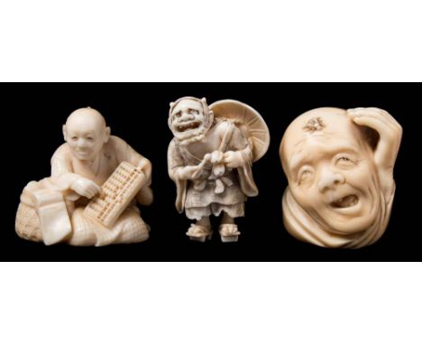 A group of two Japanese carved ivory netsukes together with an okimono: the first netsuke in the form of a seated man using a