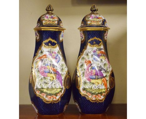 Pair of Continental porcelain hexagonal vases and covers, each having painted decoration depicting exotic birds amongst folia