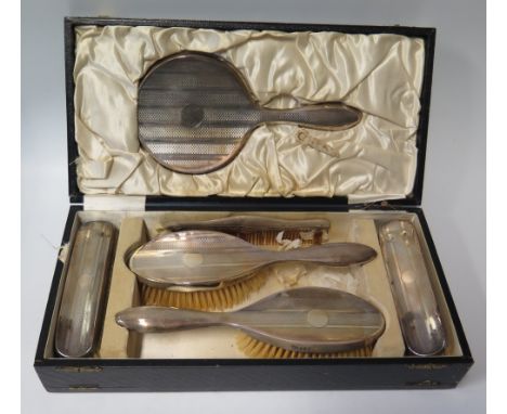 A George V Cased Silver Backed Six Part Mirror & Brush Set with engine turned decoration, Birmingham 1924, R & Co.