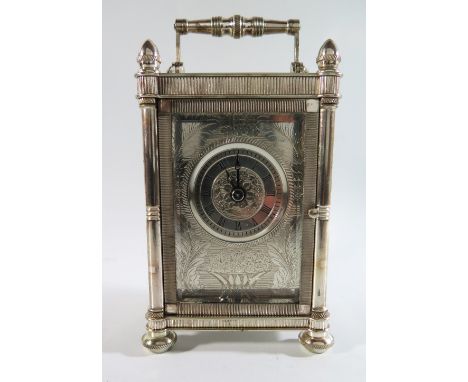 A Mappin & Webb Silver Carriage Clock with twin fusee striking movement. The silver case with chased foliate work and also to