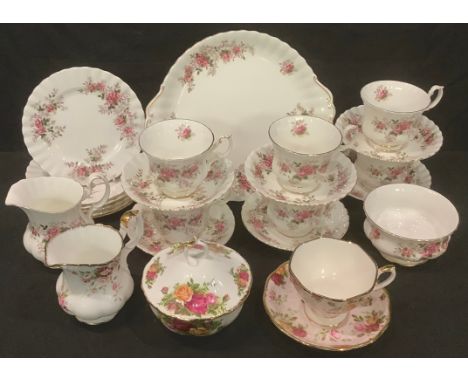 A Royal Albert Lavender Rose tea service for six comprising cake plate, cream jug, sugar bowl, side plates, cups and saucers;