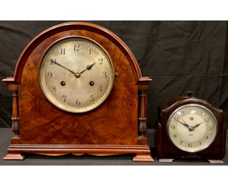 A walnut domed architectural mantel clock, silvered dial, Arabic numerals, twin winding holes, striking on a bell, key and pe