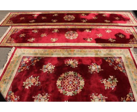 A Chinese wool rectangular carpet, 370cm x 246cm; a similar runner, 570cm x 125cm; another, 492cm x 124cm (3) 