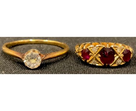 An 18ct gold ruby and diamond chip ring, size J, 3g, marked 18, original box; an unmarked gold ring, set with a single paste 