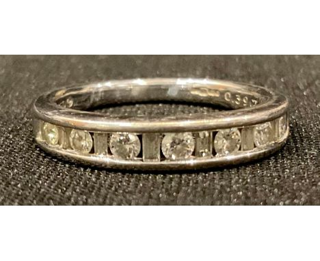 An 18ct white gold half eternity ring, with channel set diamonds, size K, 3g, boxed 