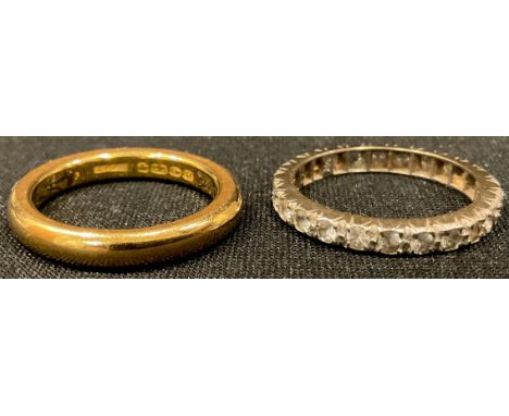 A 22ct gold wedding band, size P, 8.2g; a 9ct gold eternity ring, size P, some stones lacking, 2.4g (2) 