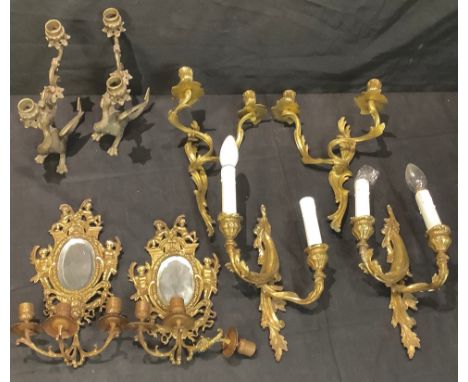 A pair of brass two light griffin candlesticks;  a pair of gilt metal two light wall lights;  others;  etc 