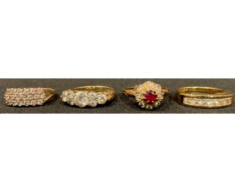 A 14ct gold dress ring, set with white stones, size N, marked 585, 2.5g; a 9ct gold ring, set with seven graduated paste ston