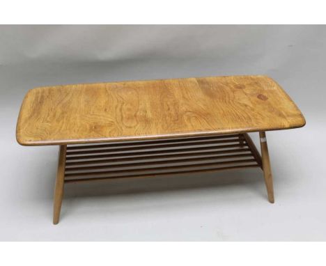 A Ercol blonde wood coffee table with magazine under tier 36x104cm retaining blue label