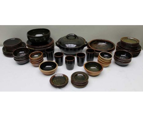 A Composite Winchcombe pottery dinner service comprising of dinner plates (26cm diameter) dessert and tea plates, beakers, bo
