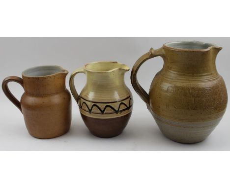 A Winchcombe pottery stoneware jug, with incised decoration, 21cm high, together with two other jugs, one a possible early Wi