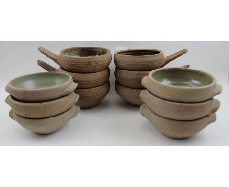 A set of six Winchcombe pottery, single handled stoneware bowls, together with a set of six two handled pottery bowls