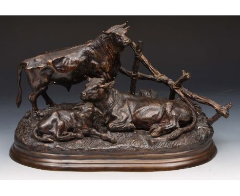 AFTER JULES MOIGNIEZ A bronze group of a bull, cow and calf beside a fence, 37cm wide
