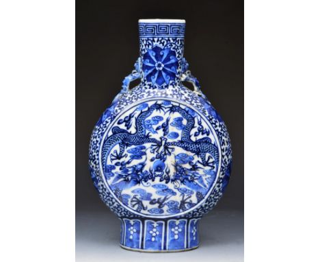 A CHINESE BLUE AND WHITE PORCELAIN MOON FLASK with stylised dragon decoration, 31cm high