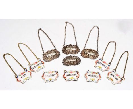 A SET OF FOUR WILLIAM IV SILVER WINE LABELS each with Bacchus mask and fruiting vine decoration, two Birmingham 1832 and two 