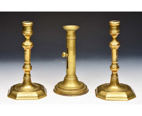 A PAIR OF 18TH CENTURY BRASS CANDLESTICKS with turned stems and eight sided bases, 20.5cm high and an antique height adjustab