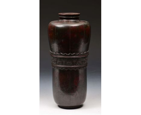 AN ANTIQUE CHINESE BRONZE VASE of tapering form with stylised decoration, signed on the base, 29cm high