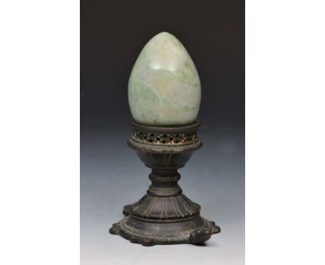 AN INDIAN BRONZE CANDLE HOLDER in the form of a turtle, 8cm high and a hardstone egg (2)