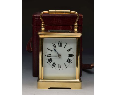 A FRENCH BRASS CARRIAGE TIMEPIECE, the white enamel dial with black Roman numerals in outer leather carrying case, 11.5cm hig