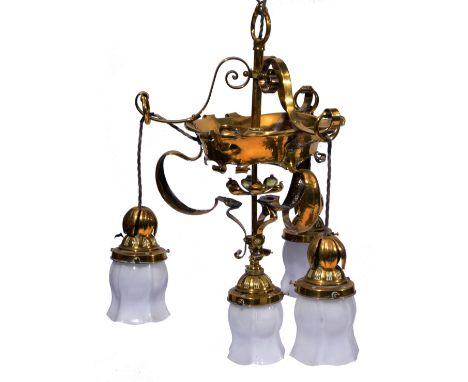 AN ART NOUVEAU BRASS CEILING LIGHT of open scroll form with four attached pendant lamps with white glass shades, approximate 