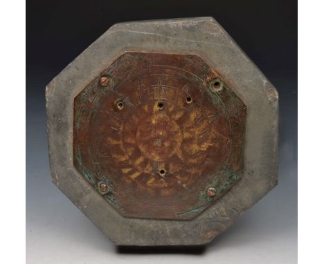 AN ANTIQUE, PROBABLY 18TH CENTURY BRONZE SUN DIAL PLATE of octagonal form upon a slate base, 15cm wide