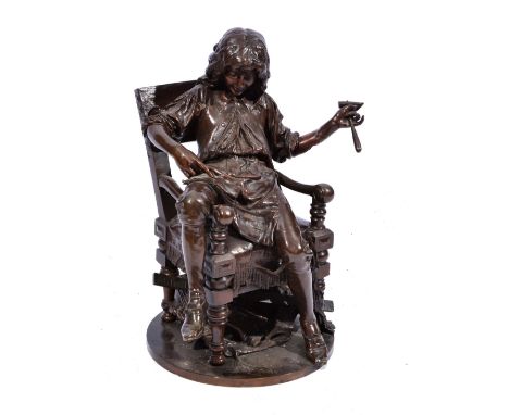 ADRIEN GAUDEZ A bronze study of a young apprentice wearing an apron reading from a manual and holding a tool with rule beneat