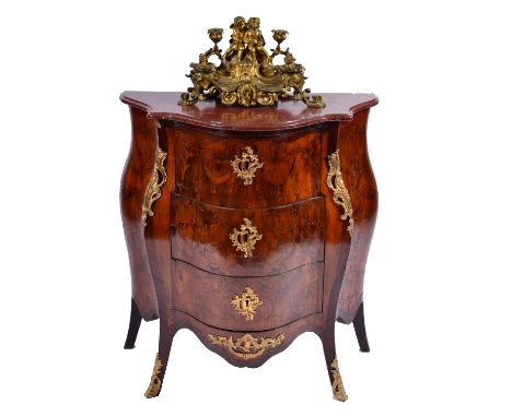 A CONTINENTAL WALNUT, KINGWOOD AND MARQUETRY BANDED BOMBÉ COMMODE with rouge marble top over three drawers with rococo gilt m