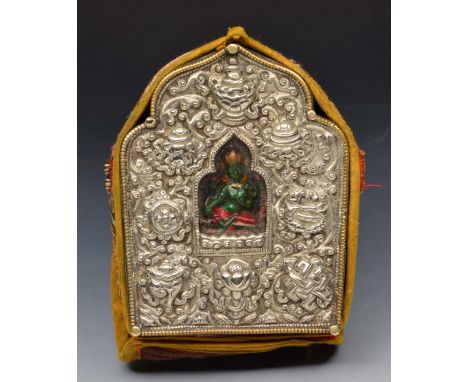 A TIBETAN SILVER SHRINE of green Tara, Goddess of Wisdom, the subject contained within a niche with embossed surround and ori