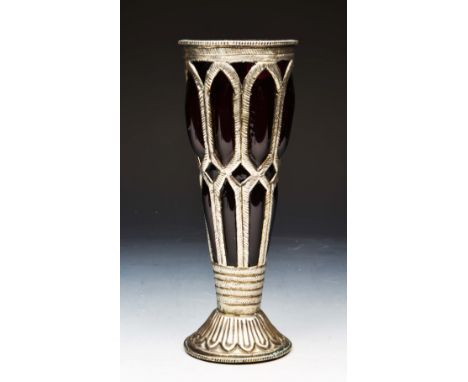 A MIDDLE EASTERN AMETHYST GLASS AND WHITE METAL CHALICE OR VASE of tapering form on a circular base, 23cm high