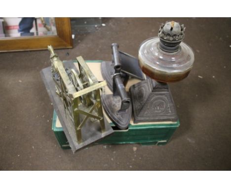 A TRAY CONTAINING A BRASS COAL MINING ORNAMENT  ON  WOODED PLINTH, TWO FLAT IRONS AND A LARGE POCKET WATCH, OIL LAMP WITH CAS