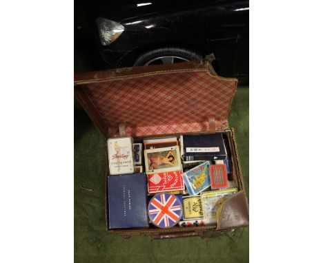 A LEATHER CASE CONTAINING PACKS OF PLAYING CARDS, GLAMOUR CARDS INCLUDED 