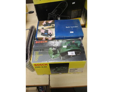 A BOSCH PH01582 PLANER TOGETHER WITH A NEWPOWER BELT SANDER WITH A ROLL OF SHEETS A/F