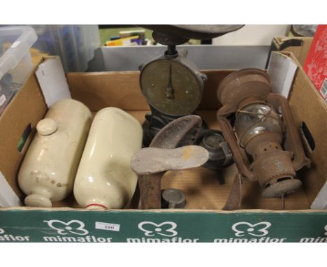 A TRAY OF ODDMENTS TO INCLUDE VINTAG WEIGHING SCALES, HURRICANE LAMP, CERAMIC HOT WATER BOTTLES AND SHOE LAST