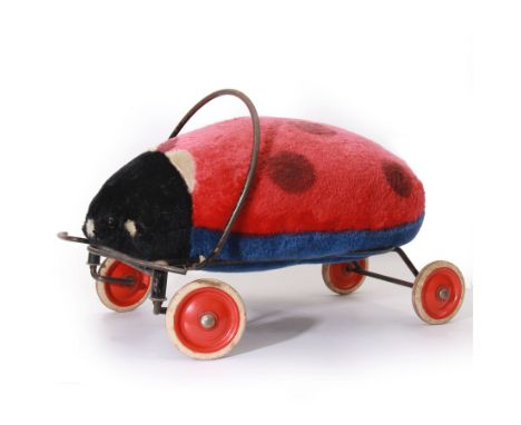 Steiff child's ride on ladybird, circa 1950s, the mohair body with red and black spotted seat, black and white face and blue 