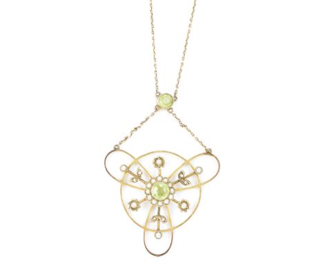 An Edwardian yellow metal peridot and seed pearl pendant on a fine 9ct gold chain, in a stylized floral design having a centr