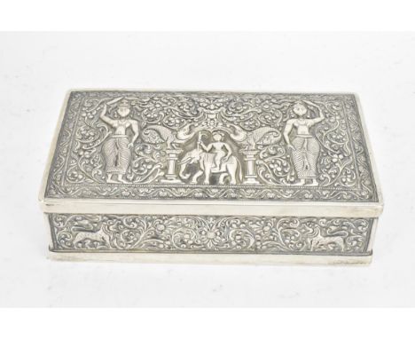 An early/mid 20th century Indian silver cigarette box, the lid and side panels embossed with scenes of figures and animals su