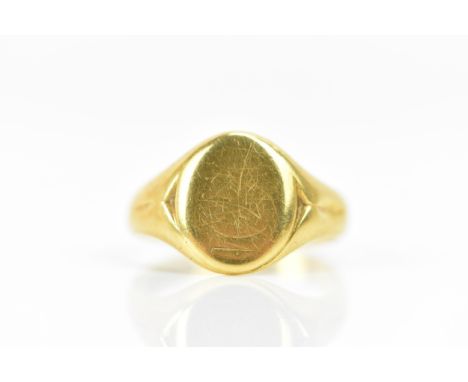 An 18ct yellow gold gents signet ring, having incised shoulders and faded engraved initials, ring size T, 8.5 grams 