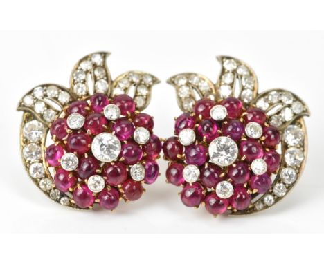 A pair of white metal flower design diamond and ruby earrings set each having central brilliant cut diamonds surrounded by ru