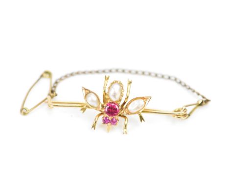 An 18ct gold ruby, pearl and red glass bug brooch, the eyes inset with two rubies with a larger red coloured stone below and 